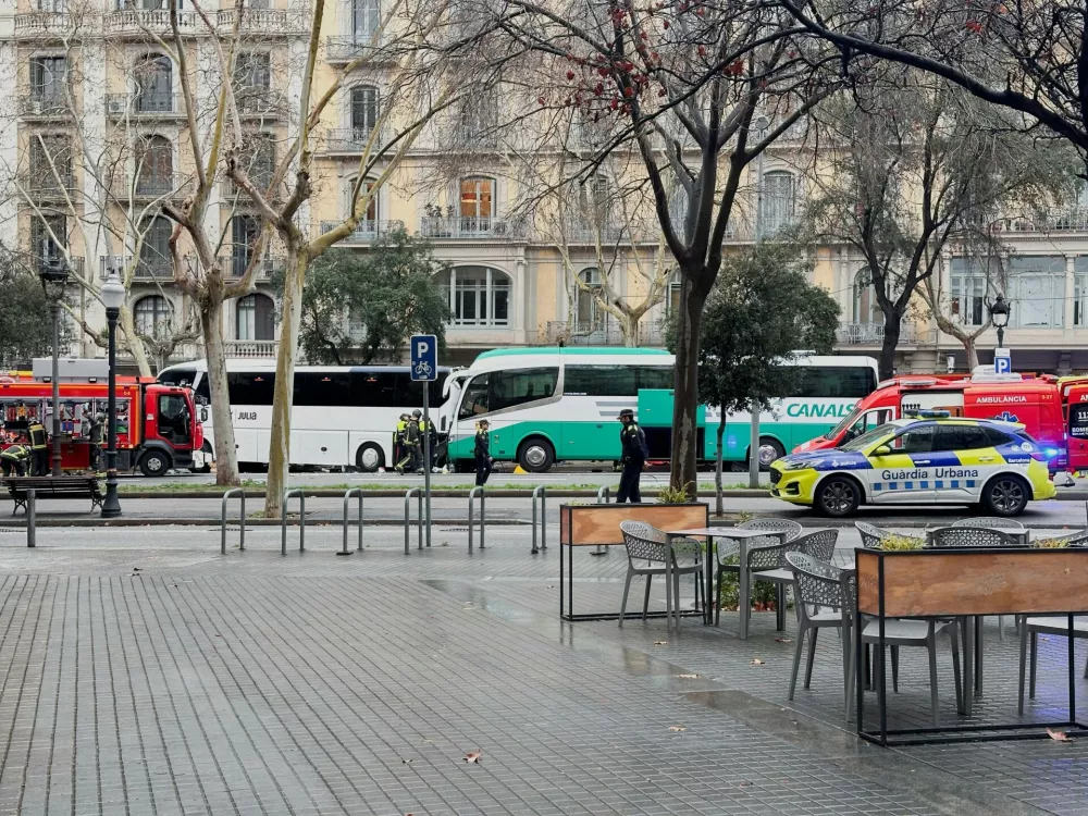 Emergency services work at the site of a collision between two buses carrying tourists, in which several people were injured, in central Barcelona, Spain, March 3, 2025. REUTERS/Horaci Garcia