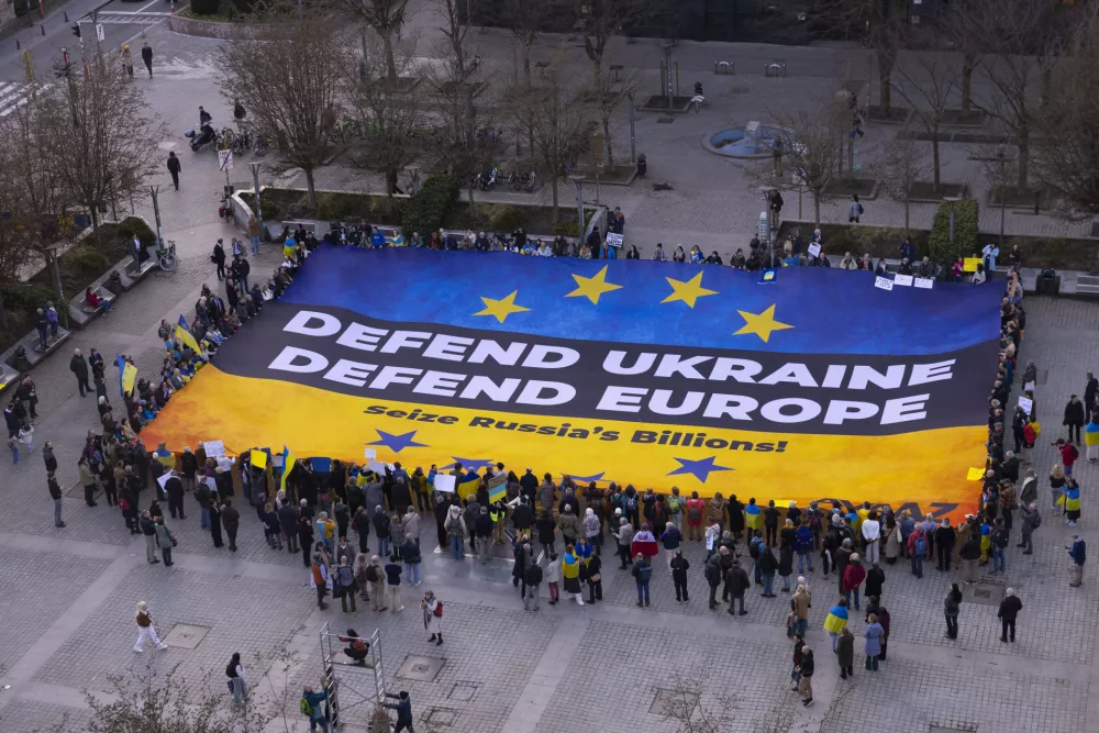 IMAGE DISTRIBUTED FOR AVAAZ.ORG - Demonstrators gather around a banner in support of Ukraine on Wednesday, March 5, 2025 in Brussels. (Javier Bernal/AP Content Services for Avaaz.org)