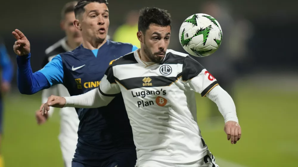 Lugano's Milton Valenzuela, right, is challenged by Celje's Juanjo Nieto during the Conference League round of 16 first leg soccer match between Celje and Lugano in Celje, Slovenia, Thursday, March 6, 2025. (AP Photo/Darko Bandic)