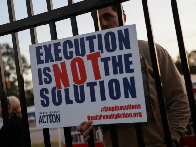 A demonstrator holds a sign outside the South Carolina Department of Corrections (SCDC), following the execution of death row inmate Brad Sigmon, 67, by firing squad method, at the Broad River Correctional Institution in Columbia, South Carolina, U.S., March 7, 2025. REUTERS/Shannon Stapleton
