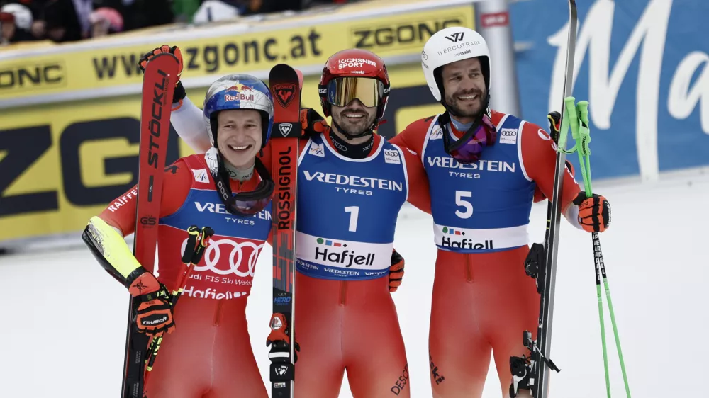Switzerland's Loic Meillard, center, winner of an alpine ski, men's World Cup Giant Slalom, celebrates with second-placed Switzerland's Marco Odermatt, left, and third-placed Switzerland's Thomas Tumler, in Hafjell, Norway, Saturday, March 15, 2025. (AP Photo/Gabriele Facciotti)
