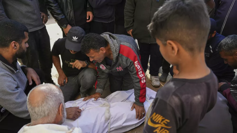 Palestinians mourn over the bodies of their relatives killed by an Israeli airstrike in Beit Lahiya, northern Gaza Strip on Saturday, March 15, 2025. (AP Photo/Jehad Alshrafi)