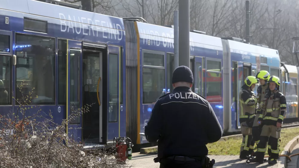 A police officer stands in front of a streetcar after an arson attack was carried out on a woman in that streetcar in Gera, Germany, Sunday, March 16, 2025. Bodo Schackow/dpa/dpa via AP)