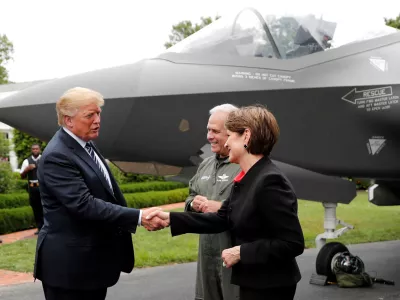 FILE PHOTO: U.S. President Donald Trump greets Lockheed Martin CEO Marillyn Hewson in front of a Lockheed Martin F-35 stealth fighter on the driveway abutting the South Lawn prior to delivering remarks at a showcase of American-made products event at the White House in Washington, U.S., July 23, 2018. REUTERS/Carlos Barria/File Photo