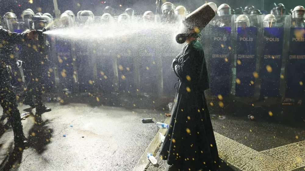Police officers use pepper spray on a demonstrator wearing dervish clothes, during a protest on the day Istanbul Mayor Ekrem Imamoglu was jailed as part of a corruption investigation, in Istanbul, Turkey, March 23, 2025. REUTERS/Umit Bektas