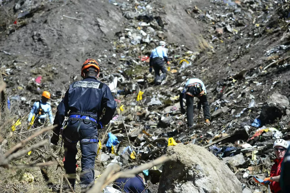 ﻿ATTENTION EDITORS - VISUAL COVERAGE OF SCENES OF INJURY OR DEATH French gendarmes and investigators, seen in this picture released by the French Interior Ministry March 26, 2015, make their way through debris from wreckage on the mountainside at the crash site of an Airbus A320, near Seyne-les-Alpes. A young German co-pilot locked himself in the cockpit of Germanwings flight 9525 and flew it into a mountain, killing all 150 people on board including himself, prosecutors said on Thursday. After listening to "black box" voice recordings, French prosecutors left no doubt that they believe 28-year-old Andreas Lubitz was in control of the Airbus A320 and set it on its fatal descent. They offered no explanation for his motive. REUTERS/French Interior Ministry/DICOM/F.Pellier /Handout TPX IMAGES OF THE DAY) FOR EDITORIAL USE ONLY. NOT FOR SALE FOR MARKETING OR ADVERTISING CAMPAIGNS. THIS IMAGE HAS BEEN SUPPLIED BY A THIRD PARTY. IT IS DISTRIBUTED, EXACTLY AS RECEIVED BY REUTERS, AS A SERVICE TO CLIENTS
