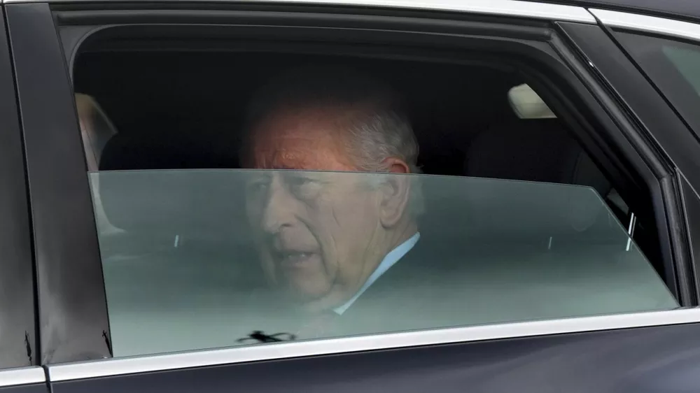 Britain's King Charles III is driven by car from Clarence House, his London home, along The Mall towards Buckingham Palace in London, Friday, March 28, 2025. (Yui Mok/PA via AP)