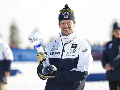 Sturla Holm Lægreid of Norway wins the overall World Cup after the biathlon men's 15 km mass start at the World Cup in Holmenkollen, Norway, Sunday, March 23, 2025. (Thomas Andersen/NTB Scanpix via AP)
