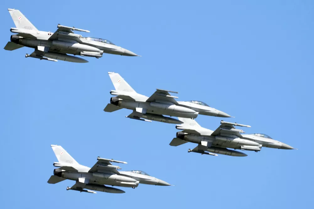 FILE - U.S. made F-16 fighter jets fly in the sky over Poland's capital as they take part in a massive military parade to celebrate the Polish Army Day, in Warsaw, Poland, Aug. 15, 2023. Ukraine has received the first tranche of western F-16 fighter jets that it has sought for months to be able to fight back against an onslaught of Russian missile strikes, a U.S. official confirmed to the Associated Press. Ukraine has been pushing to get Western F-16s for Ukraine for months, saying they were critically needed to fight back against the onslaught of missiles Russia has fired against them. (AP Photo/Czarek Sokolowski, File)