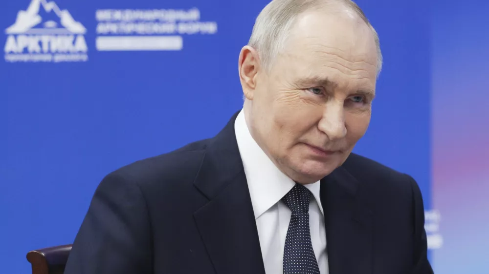 Russian President Vladimir Putin speaks with the governor of Murmansk region Andrey Chibis on the sidelines of the International Arctic Forum in Murmansk, Russia, Thursday, March 27, 2025. (Gavriil Grigorov, Sputnik, Kremlin Pool Photo via AP)