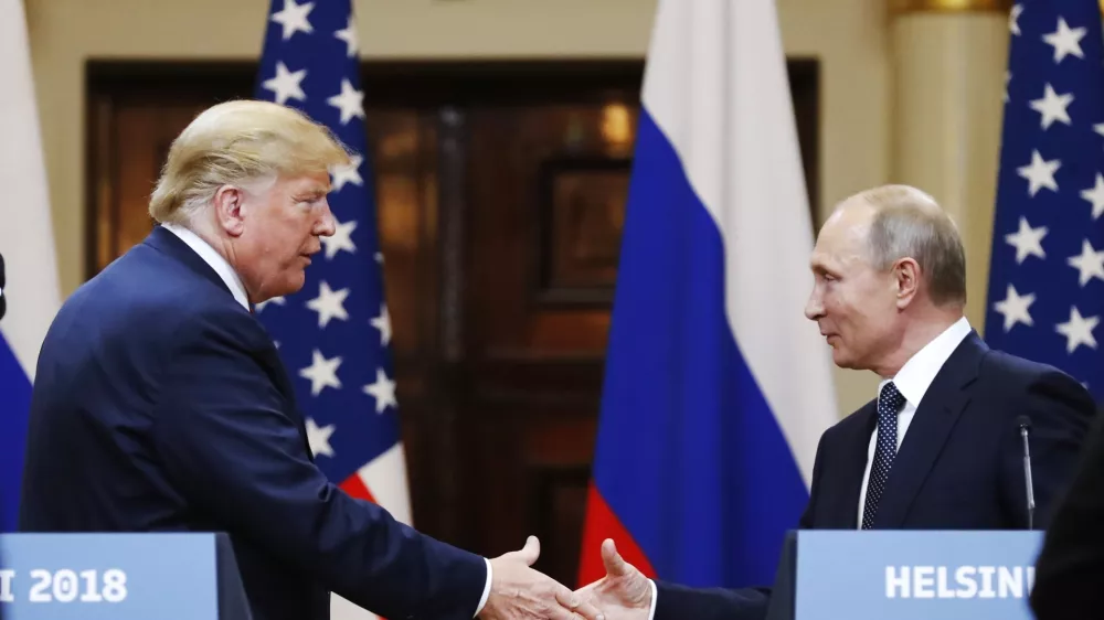 FILE - U.S. President Donald Trump shakes hands with Russian President Vladimir Putin at the end of a news conference at the Presidential Palace in Helsinki, Finland, on July 16, 2018. (AP Photo/Alexander Zemlianichenko, File)