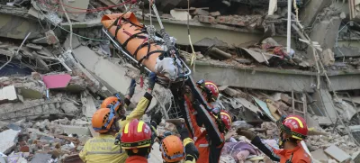 In this photo released by Xinhua News Agency, members of a China search and rescue team transfer a pregnant survivor from a collapsed building in the aftermath of an earthquake in Mandalay, Myanmar, Monday, March 31, 2025. (Myo Kyaw Soe/Xinhua via AP)