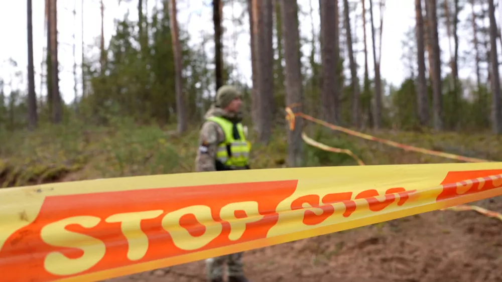 A soldier stands next to cordon tape at the scene of a rescue operation at Pabrade training ground, in Lithuania, March 31, 2025. Lithuanian Armed Forces/Handout via REUTERS ATTENTION EDITORS - THIS IMAGE HAS BEEN SUPPLIED BY A THIRD PARTY. NO RESALES. NO ARCHIVES. MANDATORY CREDIT