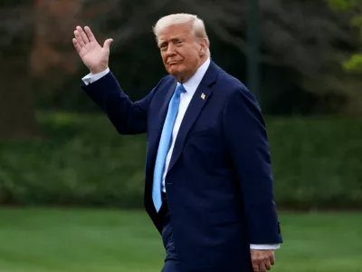 FILE PHOTO: U.S. President Donald Trump waves as he walks before departing for Florida from the South Lawn at the White House in Washington, D.C., U.S., March 28, 2025. REUTERS/Evelyn Hockstein/File Photo