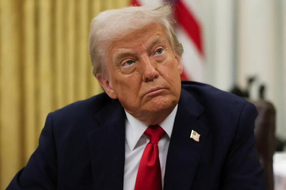 U.S. President Donald Trump prepates to sign an executive order related to the U.S. live entertainment ticketing industry in the Oval Office at the White House in Washington, D.C., March 31, 2025.  REUTERS/Leah Millis