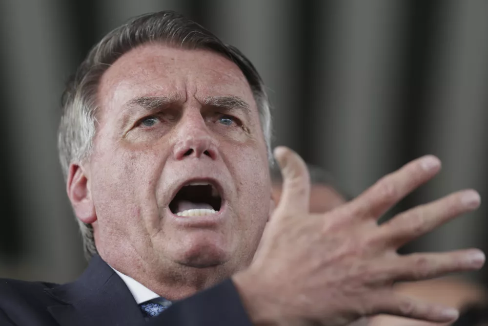 Brazil's former President Jair Bolsonaro speaks to the press at Congress in Brasilia, Brazil, Wednesday, March 26, 2025, after panel of Brazil Supreme Court justices accepted charges against him over an alleged attempt to stay in office after his 2022 election defeat. (AP Photo/Luis Nova)