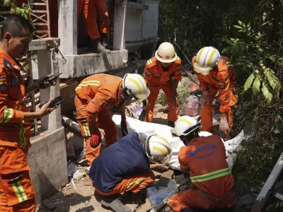 Myanmar's rescuers recover a body from a collapsed building following Friday's earthquake in Naypyitaw, Myanmar, Tuesday, April 1, 2025. (AP Photo)