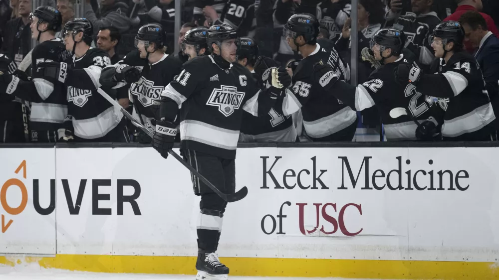 Los Angeles Kings center Anze Kopitar (11) celebrates his goal with the bench during the first period of an NHL hockey game against the Winnipeg Jets, Tuesday, April 1, 2025, in Los Angeles. (AP Photo/Kyusung Gong)