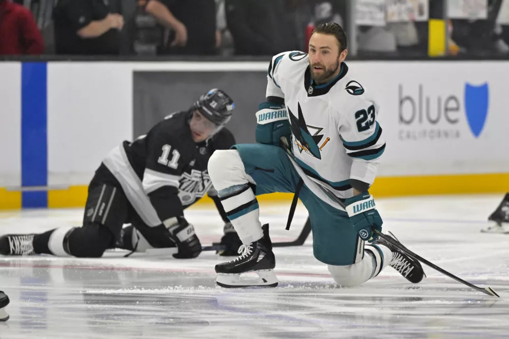 Mar 30, 2025; Los Angeles, California, USA; San Jose Sharks right wing Barclay Goodrow (23) and Los Angeles Kings center Anze Kopitar (11) warm up prior to the game at Crypto.com Arena. Mandatory Credit: Jayne Kamin-Oncea-Imagn Images