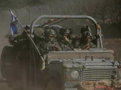 FILE PHOTO: An Israeli military vehicle rides on the Golan Heights side of the ceasefire line with Syria, as seen from Majdal Shams in the Israeli-occupied Golan Heights, December 18, 2024. REUTERS/Shir Torem/File Photo