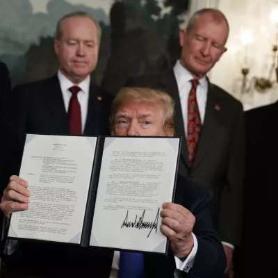 ﻿President Donald Trump displays signs a presidential memorandum imposing tariffs and investment restrictions on China in the Diplomatic Reception Room of the White House, Thursday, March 22, 2018, in Washington. (AP Photo/Evan Vucci)