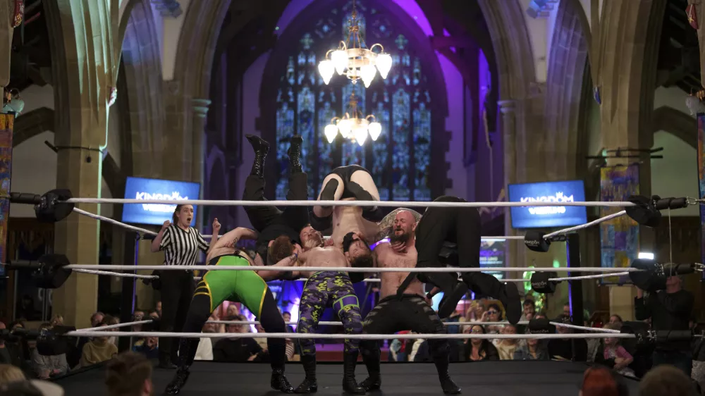 A six-man-scramble plays out in the ring at a Kingdom Wrestling show at St Peter's Church in Shipley, Saturday, March 29, 2025. (AP Photo/Jon Super)
