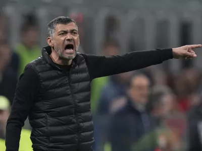 AC Milan's head coach Sergio Conceicao calls out to his players during an Italian Cup semi final first leg soccer match between AC Milan and Inter Milan at the San Siro stadium, in Milan, Italy, Wednesday, April 2, 2025. (AP Photo/Antonio Calanni)