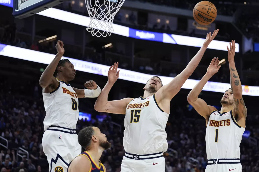 Denver Nuggets center Nikola Jokic (15) rebounds the ball during the second half of an NBA basketball game against the Golden State Warriors, Friday, April 4, 2025, in San Francisco. (AP Photo/Godofredo A. Vásquez)