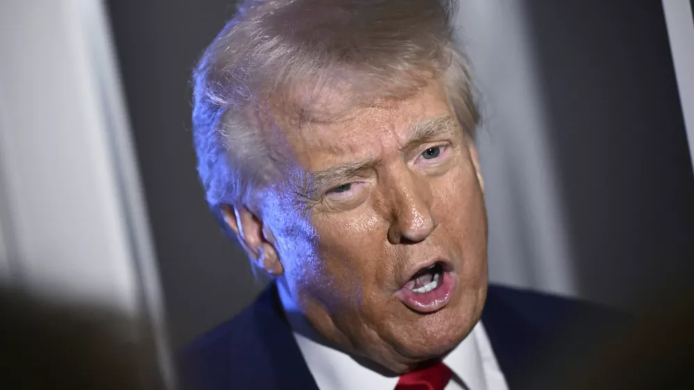 President Donald Trump speaks to reporters while in flight on board Air Force One, en route to Miami, Thursday, April 3, 2025. (Pool via AP)
