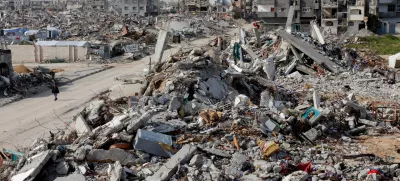 A Palestinian walks past a rubble of houses destroyed during the Israeli offensive, in Rafah, in the southern Gaza Strip, March 13, 2025. REUTERS/Hatem Khaled