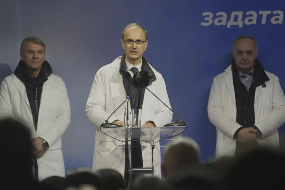 Djuro Macut, center, a politically inexperienced medical professor and nominated to become Serbia's prime minister, speaks during a rally in a central town of Jagodina, Serbia, Friday, Jan. 24, 2025. (AP Photo/Antonio Ahel)