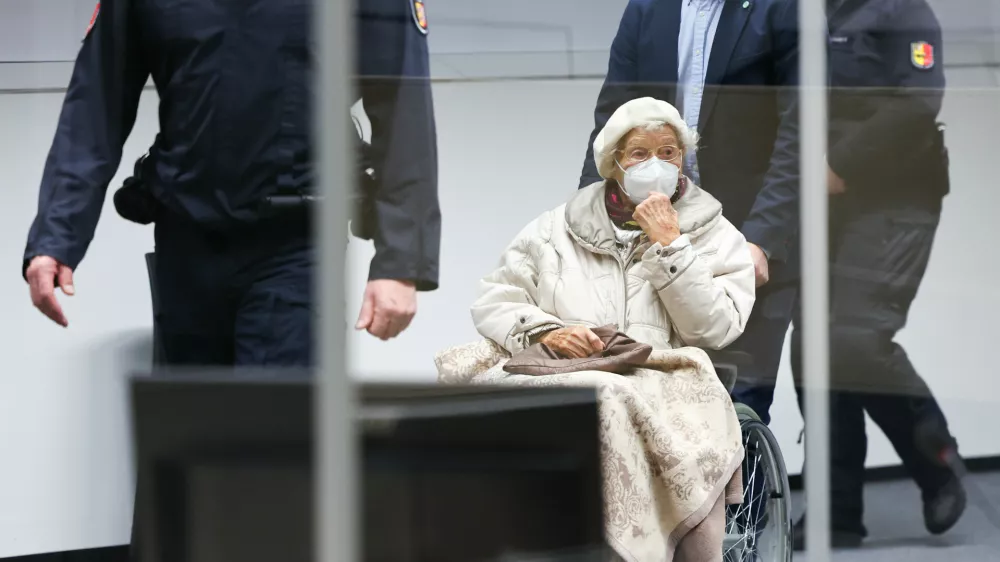 FILED - 20 December 2022, Itzehoe: The defendant Irmgard F.,charged with aiding mass murder in over 11,000 cases in the Stutthof concentration camp, is brought into the courtroom at the beginning in Itzehoe. The 99-year-old former secretary at the Stutthof concentration camp convicted for aiding and abetting the mass murder of more than 10,000 people between June 1943 and April 1945 has died, prosecutors said on Monday. Photo: Christian Charisius/dpa/Pool/dpa