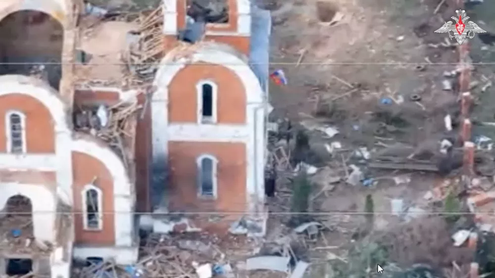 A Russian flag flies from the window of a destroyed church in the village of Guyevo, which was recently retaken by Russia's armed forces, according to the Russian Defence Ministry, in the course of Russia-Ukraine conflict in the Kursk region, Russia, in this still image taken from video released April 8, 2025. Russian Defence Ministry/Handout via REUTERS ATTENTION EDITORS - THIS IMAGE HAS BEEN SUPPLIED BY A THIRD PARTY. NO RESALES. NO ARCHIVES. MANDATORY CREDIT. WATERMARK FROM SOURCE.