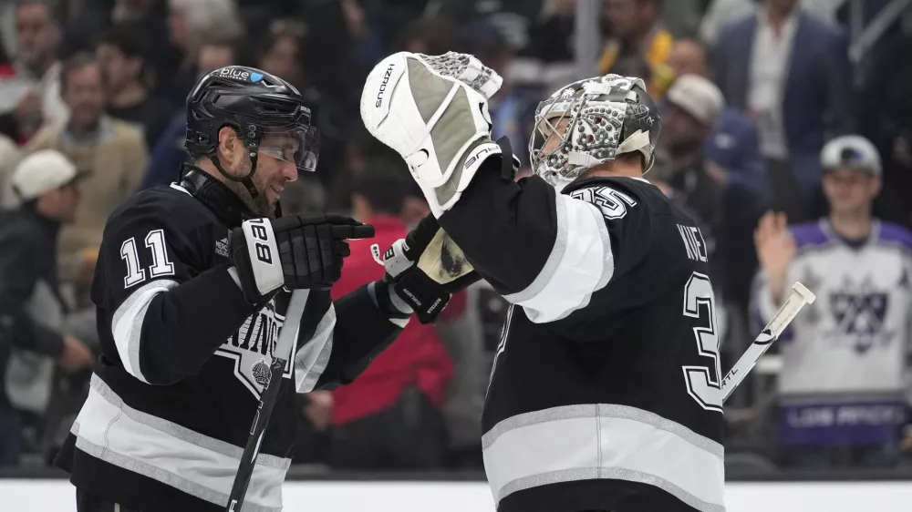 Los Angeles Kings center Anze Kopitar, left, and goaltender Darcy Kuemper congratulate each other after the Kings defeated the Anaheim Ducks in an NHL hockey game Thursday, April 10, 2025, in Los Angeles. (AP Photo/Mark J. Terrill)