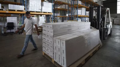 An employee inspects stocks before they are loaded onto a container for shipping to the U.S. at Corporate Specialist's furniture factory on the outskirts of Muar, in Johor state of Malaysia, Friday, April 11, 2025. (AP Photo/Vincent Thian)