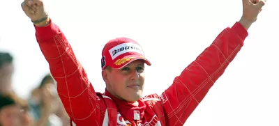 FILED - 10 September 2006, Italy, Monza: Formula 1 legend Michael Schumacher, then of Scuderia Ferrari, celebrates his victory at the Italian Grand Prix in Monza. Schumacher has signed a crash helmet which will be auctioned for Jackie Stewart's dementia charity. Photo: Gero Breloer/dpa
