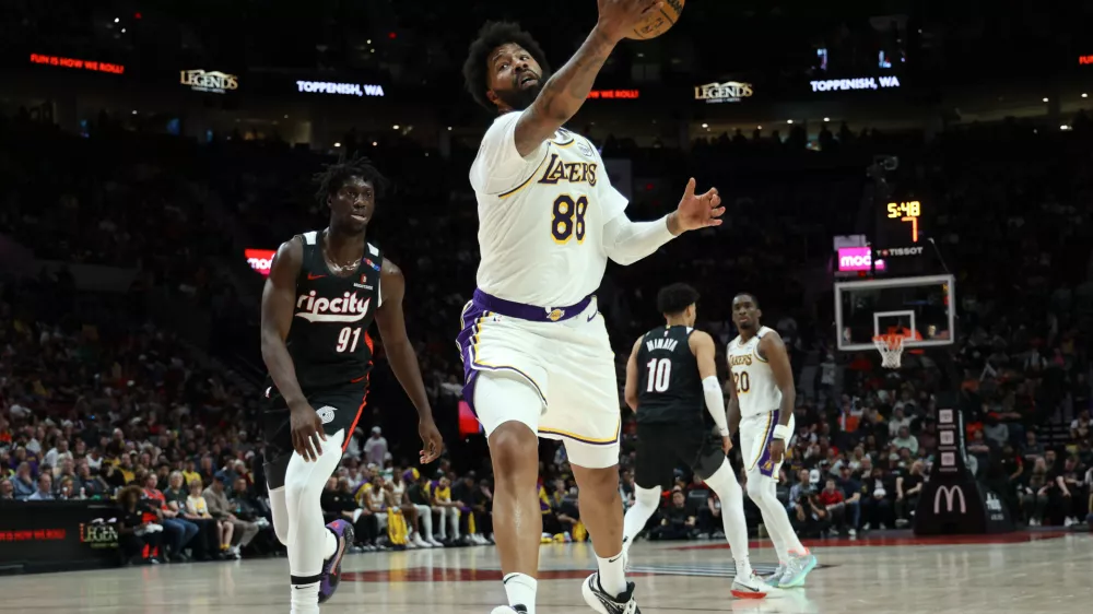 Apr 13, 2025; Portland, Oregon, USA; Los Angeles Lakers forward Markieff Morris (88) catches the ball against Portland Trail Blazers guard Sidy Cissoko (91) in the second half at Moda Center. Mandatory Credit: Jaime Valdez-Imagn Images