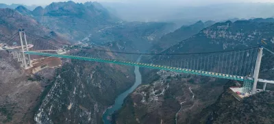 ZHENFENG, Jan. 17, 2025 -- An aerial drone photo taken on Jan. 17, 2025 shows a view of the Huajiang Grand Canyon Bridge in southwest China's Guizhou Province. China on Friday finished the construction of the main structure of the Huajiang Grand Canyon Bridge in its southwestern Guizhou Province, which is set to become the world's tallest bridge. A project of Guizhou Transportation Investment Group Co., Ltd., the suspension bridge has a vertical height of 625 meters from the bridge deck down to the river surface. The 2,890-meter bridge, with a span of 1,420 meters, is also the world's largest span bridge to be built in a mountainous area.,Image: 954481489, License: Rights-managed, Restrictions:, Model Release: noFoto: Profimedia