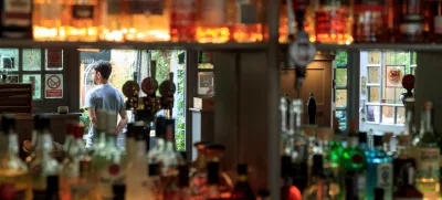 Staff members stand by the entrance of the Red Lion and Sun in London, Britain, August 30, 2022. REUTERS/May James