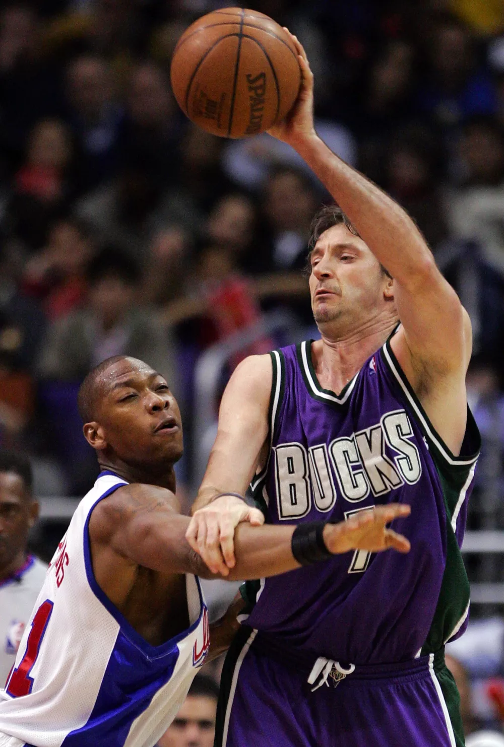 Milwaukee Bucks' Toni Kukoc of Croatia pushes the arm of Los Angeles Clippers' Bobby Simmons out of the way during the second half Wednesday, March 23, 2005, in Los Angeles. The Clippers won 116-108. (AP Photo/Mark J. Terrill)