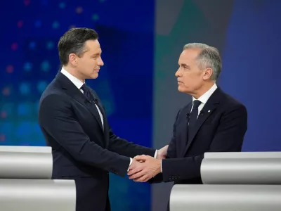 FILE PHOTO: Conservative Leader Pierre Poilievre and Liberal Leader Mark Carney shake hands following the English-language federal leaders' debate in Montreal, Canada, April 17, 2025. Christopher Katsarov/Pool via REUTERS/File Photo