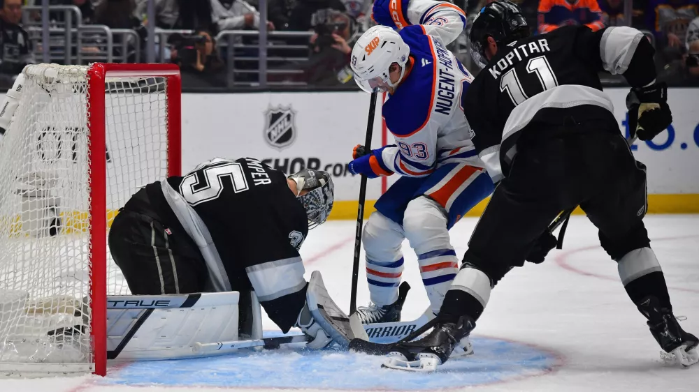 Apr 29, 2025; Los Angeles, California, USA; Los Angeles Kings center Anze Kopitar (11) helps goaltender Darcy Kuemper (35) defend the goal against Edmonton Oilers center Ryan Nugent-Hopkins (93) during the third period in game five of the first round of the 2025 Stanley Cup Playoffs at Crypto.com Arena. Mandatory Credit: Gary A. Vasquez-Imagn Images