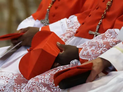 FILE - Cardinals hold the red three-cornered biretta hats before a consistory inside the St. Peter's Basilica at the Vatican, Saturday, Nov. 19, 2016. (AP Photo/Gregorio Borgia, File)