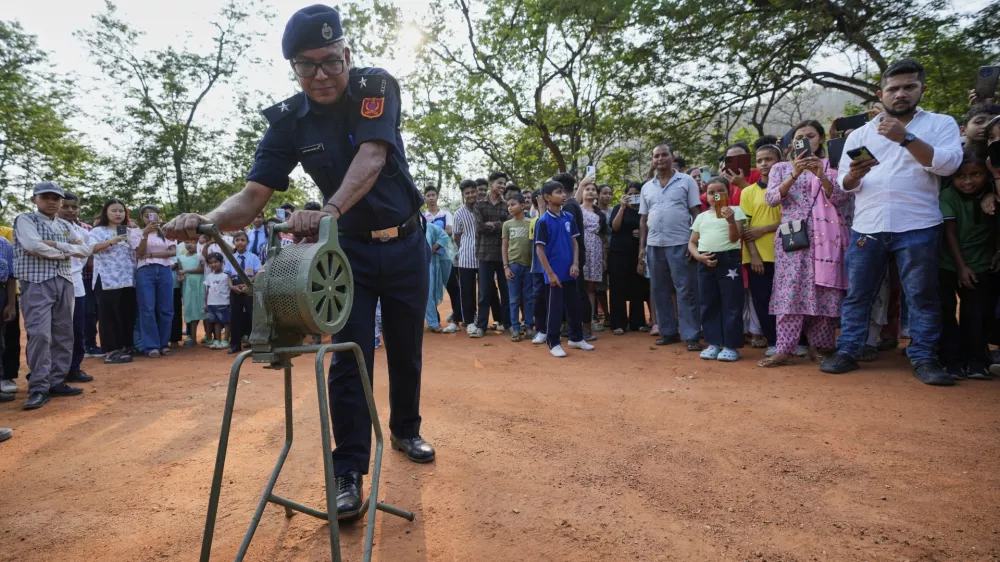 A Civil defense member blows the siren carry out a mock drill to train civilians and security personnel to respond in case of attack, in Guwahati, India, Wednesday, May 7, 2025 amid rising fears of wider conflict following India's strikes in Pakistan. (AP Photo/Anupam Nath)