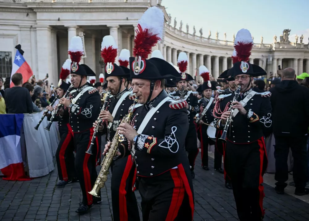 Band members perform after white smoke rose from the chimney on the Sistine Chapel, indicating that a new pope has been elected, at the Vatican, May 8, 2025.REUTERS/Dylan Martinez