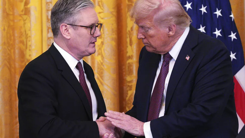 FILE - Britain's Prime Minister Keir Starmer, left, and U.S. President Donald Trump shake hands at a joint press conference in the East Room at the White House Thursday, Feb. 27, 2025, in Washington. (Carl Court/Pool Photo via AP, File)