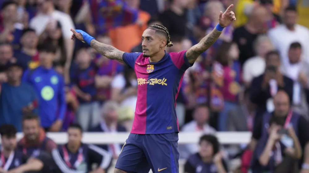 Barcelona's Raphinha celebrates scoring his side's 4th goal during the Spanish La Liga soccer match between Barcelona and Real Madrid at the Lluis Companys Olympic Stadium in Barcelona, Spain, Sunday, May 11, 2025. (AP Photo/Jose Breton)