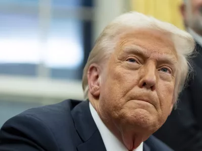 FILE - President Donald Trump speaks with reporters as he signs executive orders in the Oval Office at the White House, Feb. 10, 2025, in Washington. (AP Photo/Alex Brandon, file)