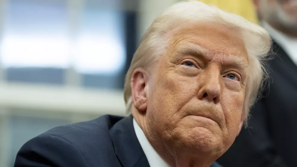 FILE - President Donald Trump speaks with reporters as he signs executive orders in the Oval Office at the White House, Feb. 10, 2025, in Washington. (AP Photo/Alex Brandon, file)