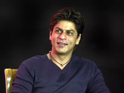 ** FILE ** Bollywood actor Shah Rukh Khan smiles during the launch of the "confidence plan" for hearing impaired by an Indian cellular company in Bombay, India, in this May 20, 2004 file photo. Bollywood leading man Shah Rukh Khan says he felt uncomfortable taking on the role of a husband who leaves his wife and child for another woman in his latest film. (AP Photo / Aijaz Rahi, file)